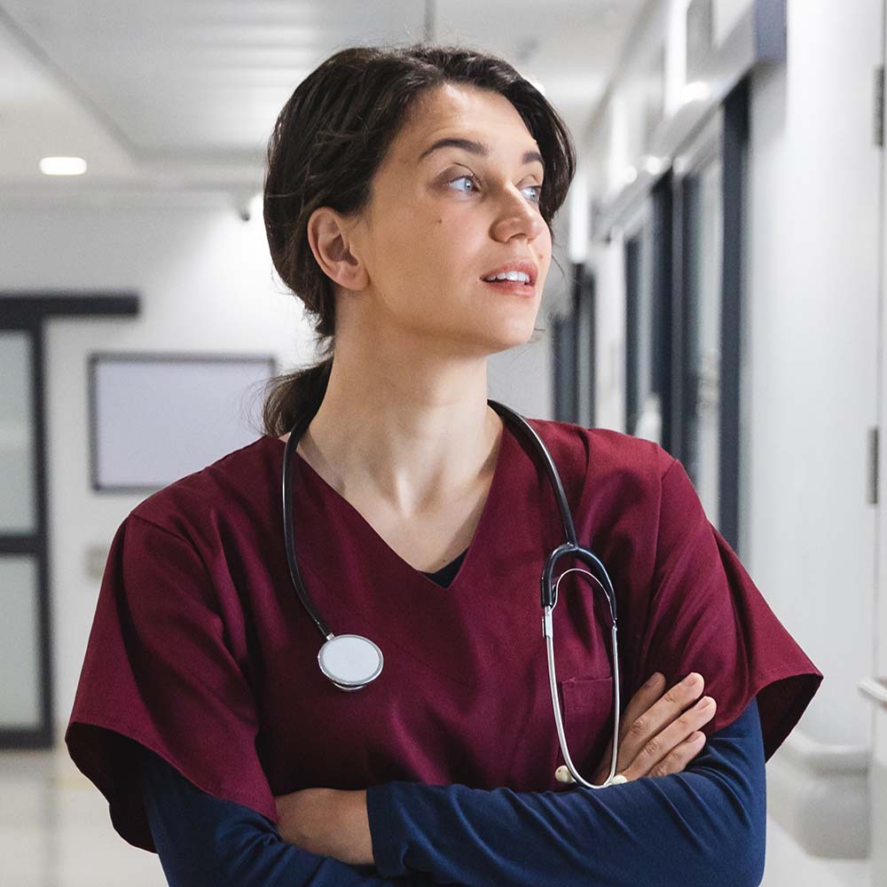 caucasian female doctor wearing scrubs and stethos 5R6NPTA